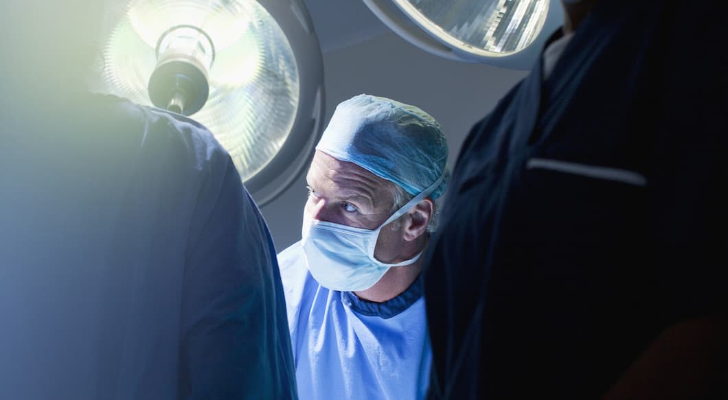 Male doctor in a surgery room with lights.